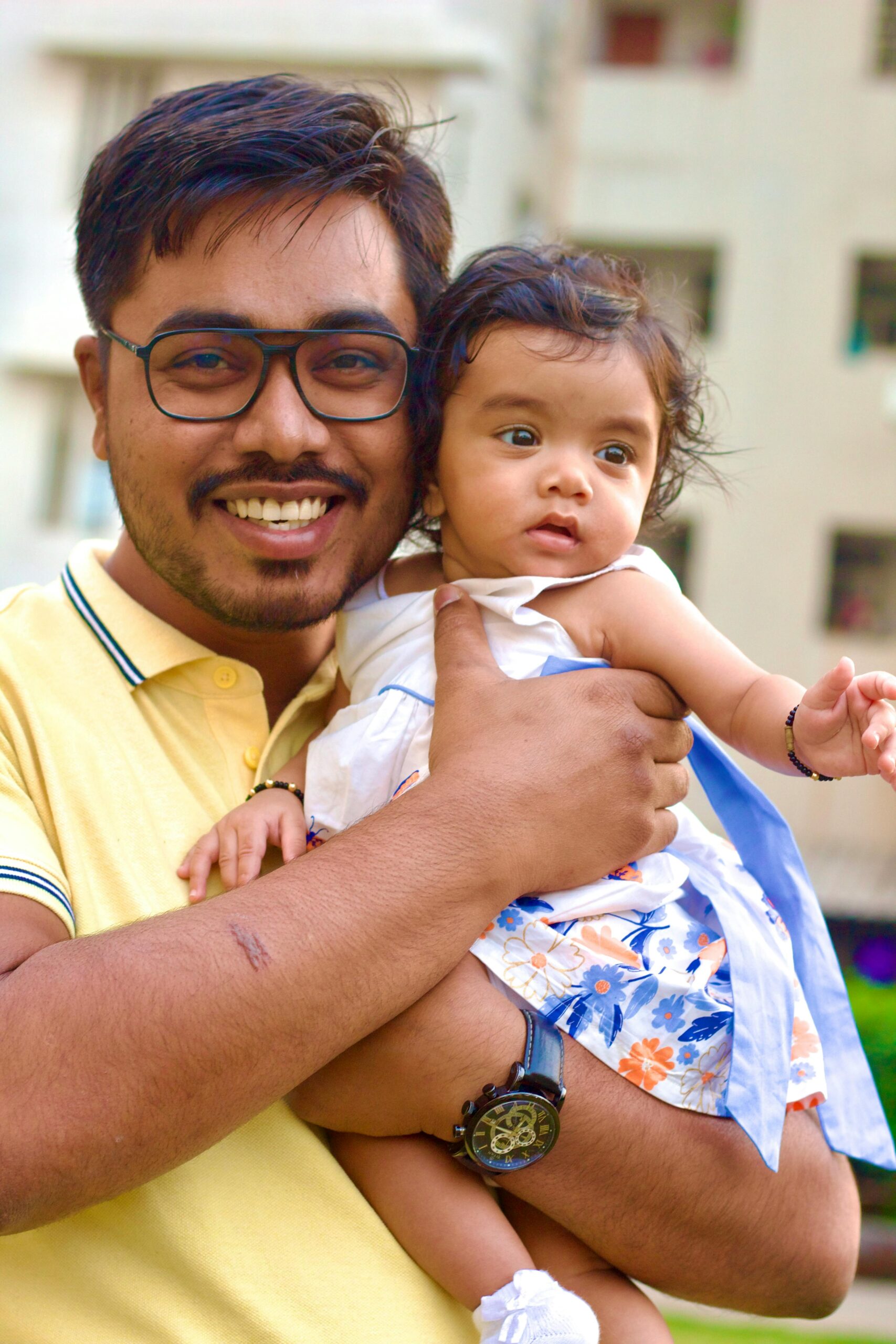 pexels-photo-20553933-20553933 Joyful father holding his baby daughter in a happy moment outdoors.